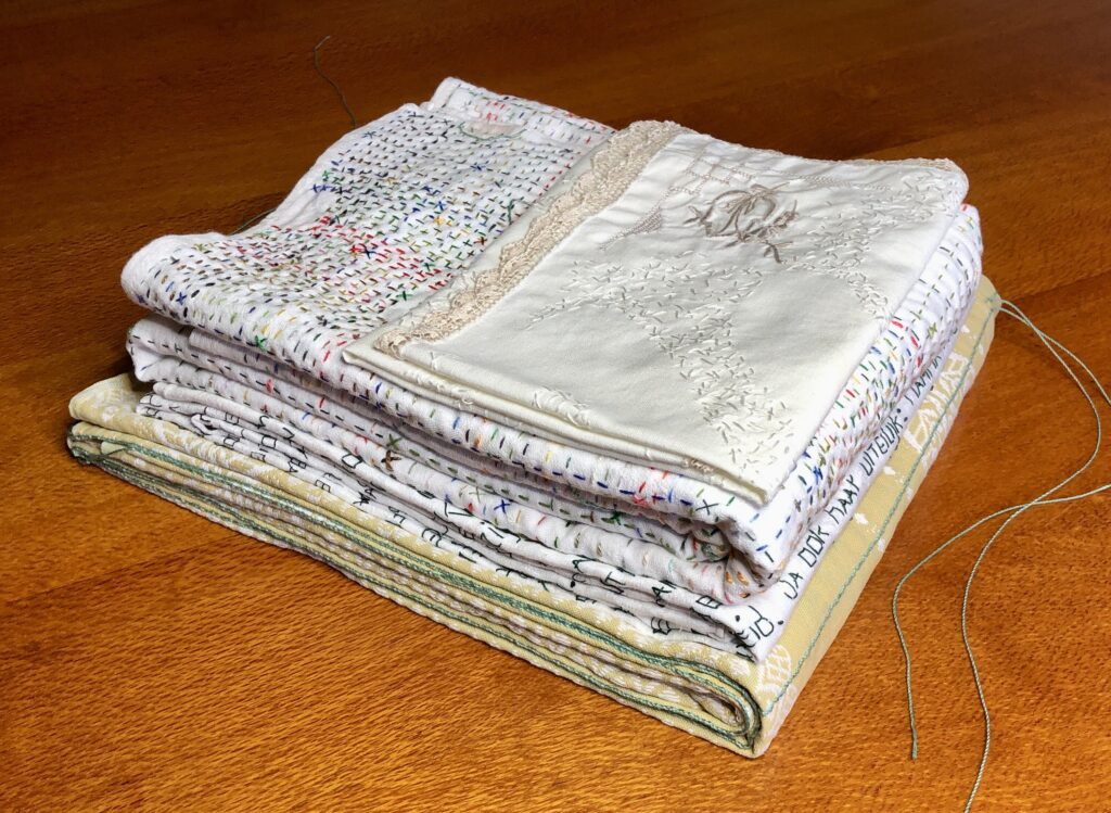 Salvaged tablecloths and napkins stitched with family stories
