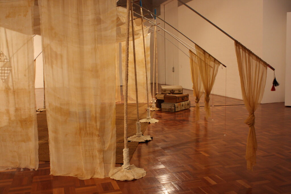 Restless Habitat installation with suitcases, wide view